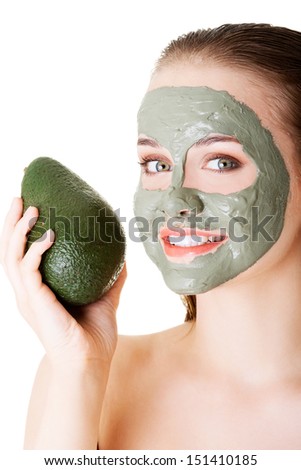 Beautiful woman with green avocado clay facial mask, isolated on white