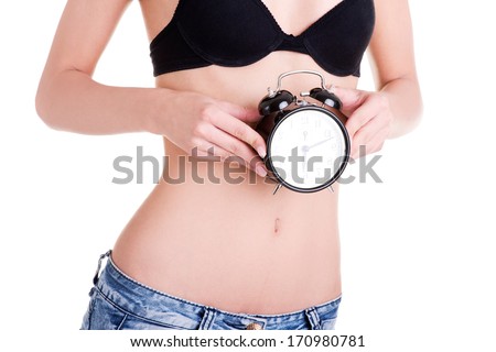 Beautiful fit belly woman with clock on belly