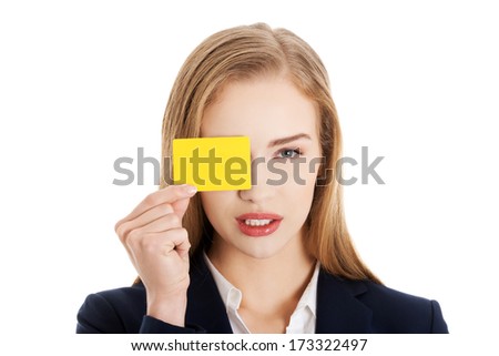 Beautiful caucasian business woman holding yellow empty personal card. Isolated on white.
