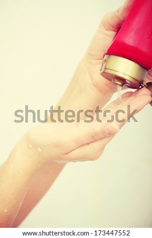 Liquid Gel Soap Pouring from Bottle into a Woman\'s Hand