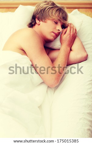 Man comfortably sleeping in his bed.