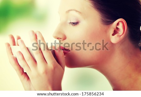 Young woman with clean face drinking grean tea - spa concept.