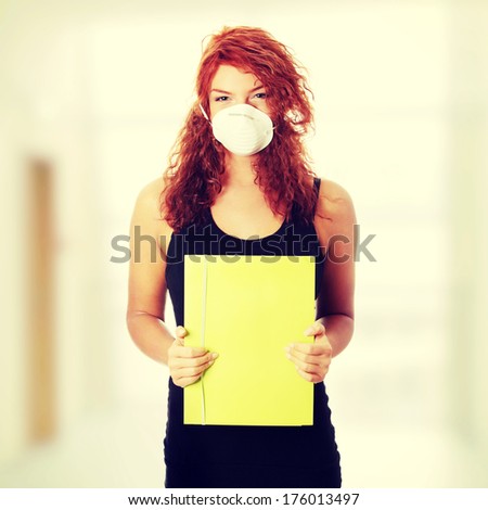 Young caucasian student woman with mask on her face. She is defending her self from viruses.