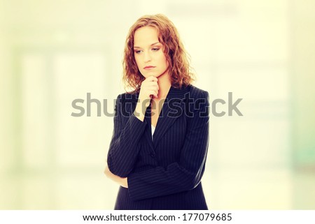 Young businesswoman thinking