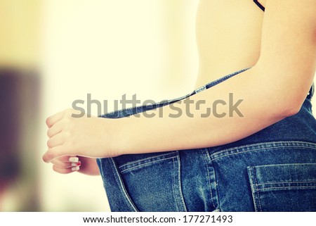 Teen woman showing how much weight she lost.