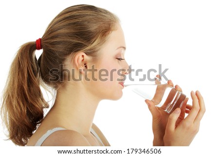 Young woman drinking fresh cold water from glass - isolated on white