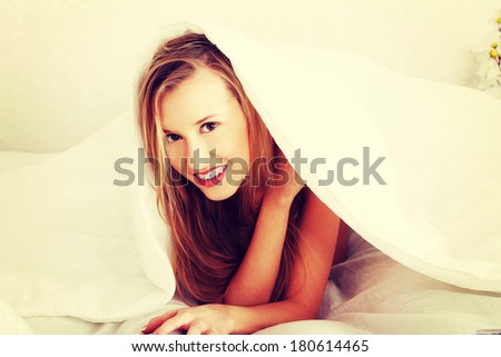 Happy, young, beautiful woman on bed have fun