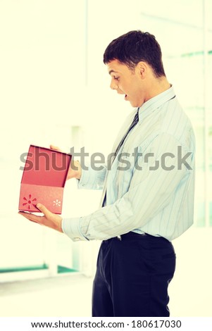 Business man opening a gift