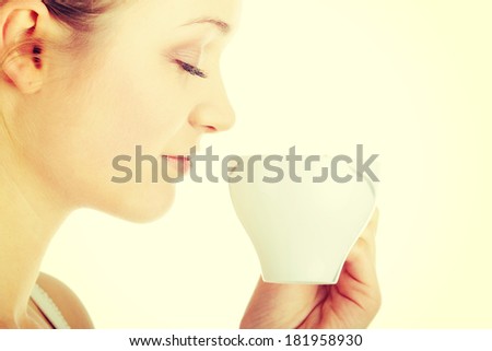 Young attractive blond woman drinking coffee, isolated on white background