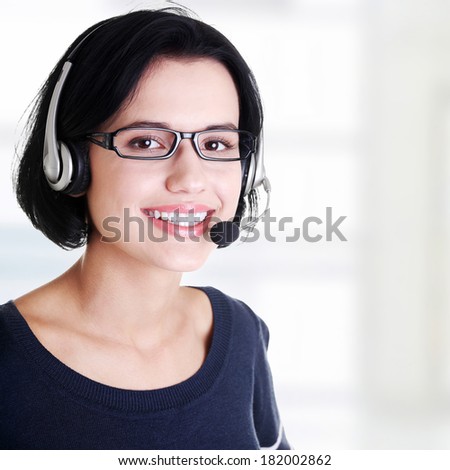 Closeup of attractive customer support representative smiling with headset