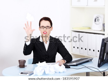 Stressed business woman is working with documents in office.