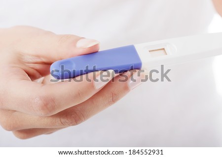 Close up on pregnancy test in female\'s hands.