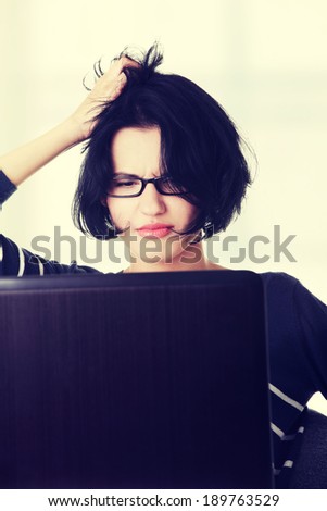 Frustrated woman working on laptop