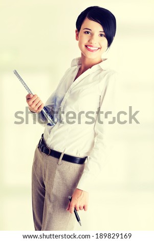 Happy smiling business woman or student in elegant clothes holding notebook and pen, isolated on white background