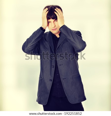 Young businessman with a big headache or problem