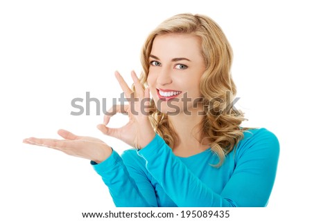 Woman showing something or copyspase for product or sign text