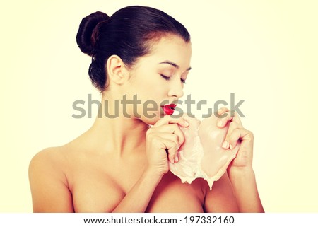 Young beautiful woman eating raw chicken meat.