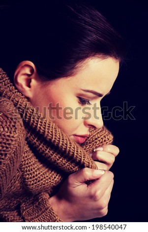 Young woman is having a depression. Over black background.