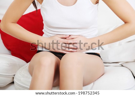 A photo of woman with stomach ache. Illness concepion.