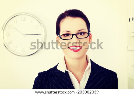 A photo of happy business woman in office. Time concept.