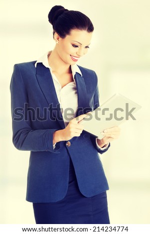 Business woman holding tablet computer with touchpad. Isolated on white.