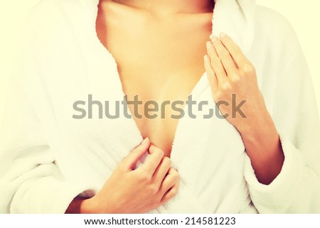 Woman in bathrobe, close up on chest. Body part.