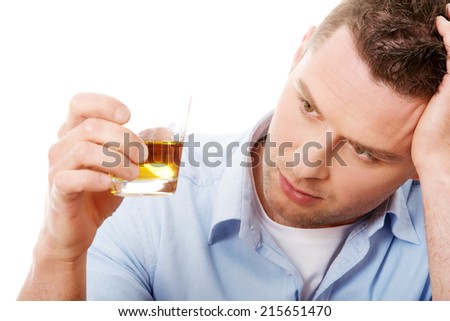 Yound man in depression, drinking whisky