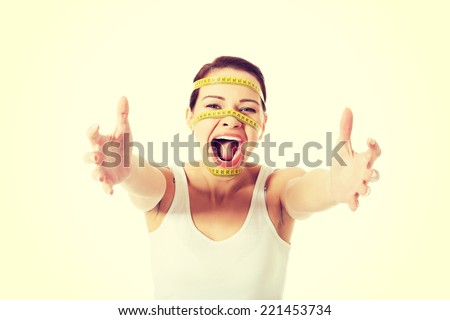 Scared woman with measuring tape on face