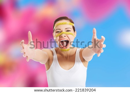 Scared woman with measuring tape on face