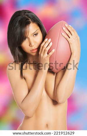 Beautiful sexy woman with American football ball
