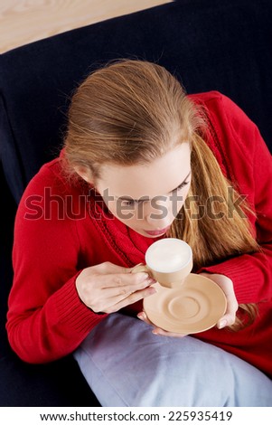 Young beautiful woman drinking coffee