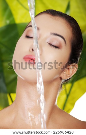 Woman\'s face hand with water splash