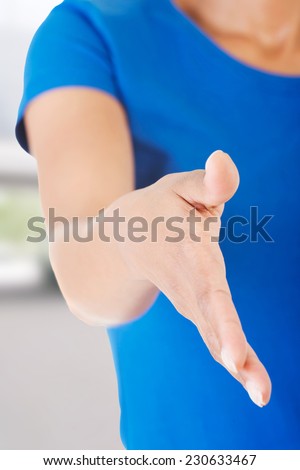 A beautiful young adult woman about to shake hands