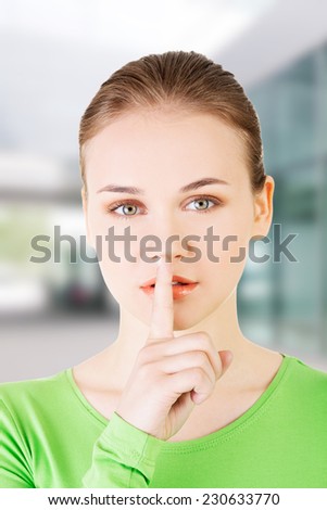 Teen girl with finger on her lips