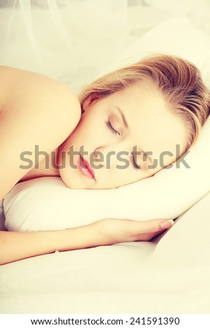 Portrait of young beautiful sleeping woman on bed at bedroom