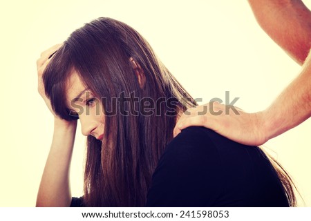 Troubled young girl comforted by her boyfriend.