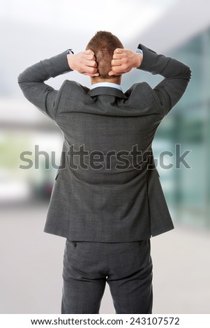 Angry businessman holding his head