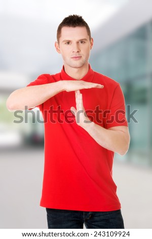 Handsome man showing time out sign with hands