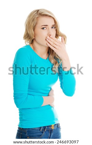 Sick woman about to throw up holding her stomach