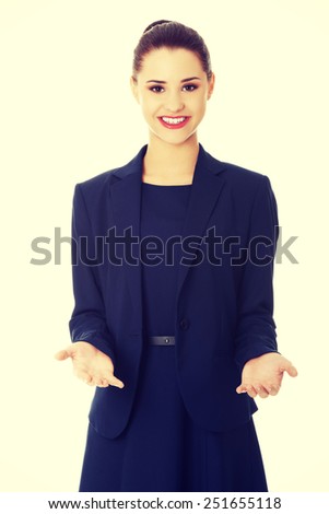 Business woman showing something or copyspase for product or sign text