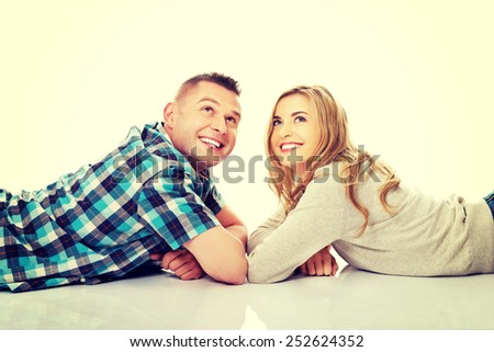 Happy couple look on empty copy space