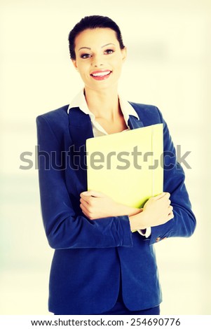 Happy smiling businesswoman holding files.