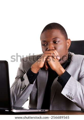 Black man sitting with the laptop on desk