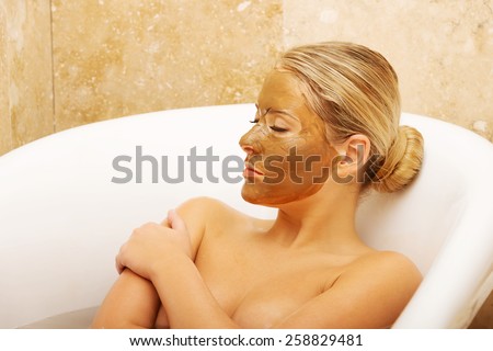 Spa serene woman relaxing in bath with chocolate face mask