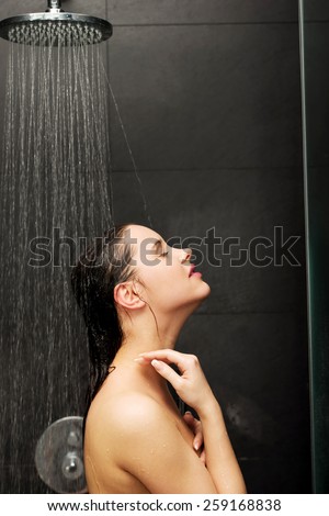 Beautiful woman standing at the shower.