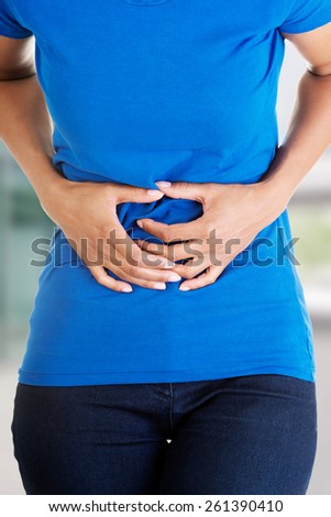 Woman heaving huge belly ache