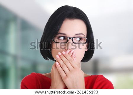 Shocked woman covering her mouth with hands.