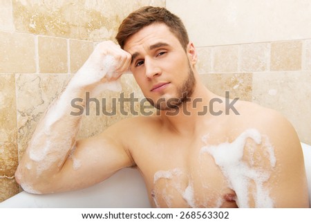Handsome man taking a bath and enjoying it.