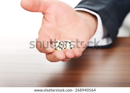Businessman\'s hand with two dices.