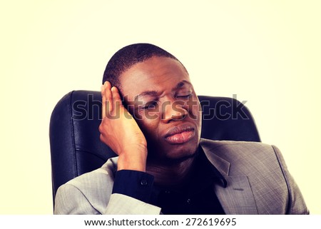Black handsome man sitting at work